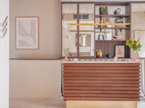 a kitchen with a wooden counter top in a room at Hôtel Basss in Paris