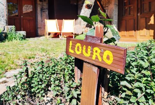 a sign with the word louino on it in a yard at Casa Boletus in Castro Laboreiro