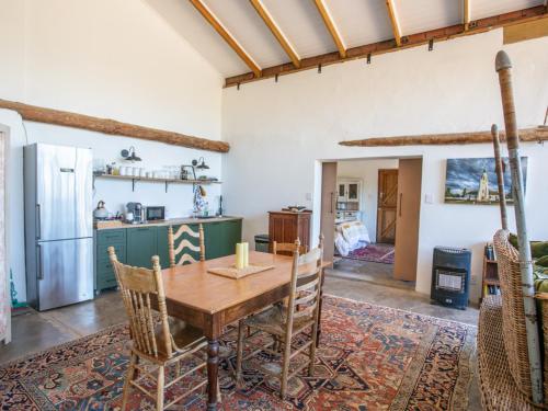 a kitchen and dining room with a wooden table and chairs at Die Stal in Worcester