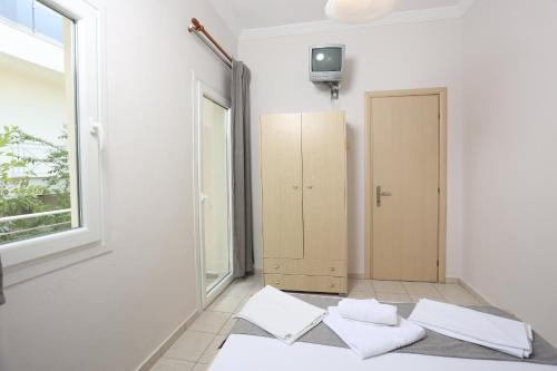 a room with a door and two pillows on the floor at Ice Hot Rooms Pefkochori in Pefkohori