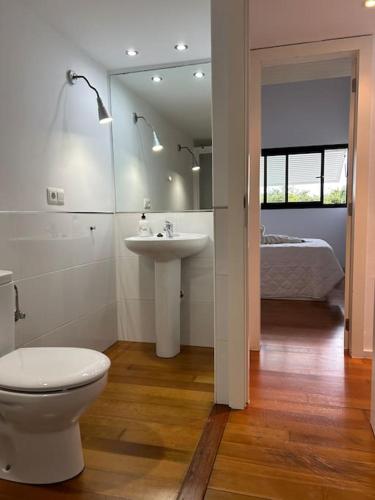 a bathroom with a toilet and a sink and a bed at Smile Seaview in Nerja