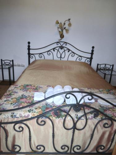 a black bed with a floral comforter on it at Xenios Petritis in Levádeia
