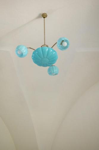 a blue chandelier hanging from a ceiling at Masseria Palombara Relais & SPA - Adults only in Manduria