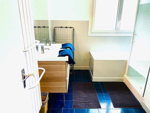 a bathroom with a sink and a shower and a tub at Les places in Savigny-en-véron