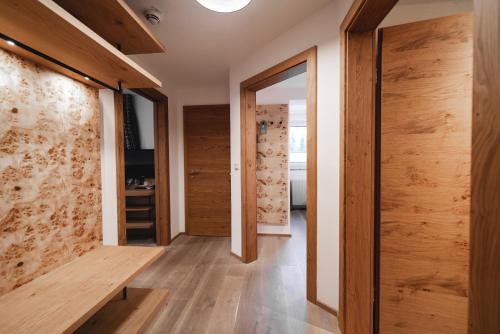 a room with wooden walls and a hallway with a wooden bench at Genusshotel Fichtenhof in Grossarl