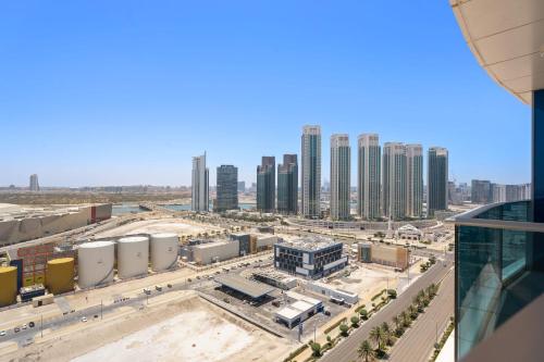 an aerial view of a city with tall buildings at Silkhaus Vacation Homes Chic 2BDR Near Reem Mall in Abu Dhabi