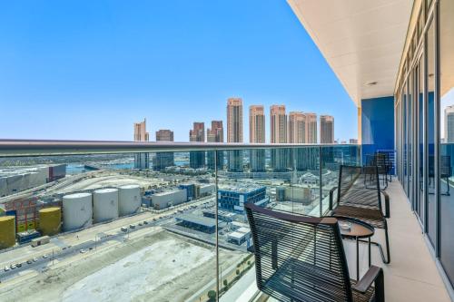 a balcony with a view of a city at Silkhaus Vacation Homes Chic 2 BDR Near Reem Central Park in Abu Dhabi