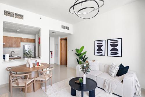 a living room with a white couch and a table at Silkhaus Vacation Homes Convenient 1BDR Near Reem Mall in Abu Dhabi