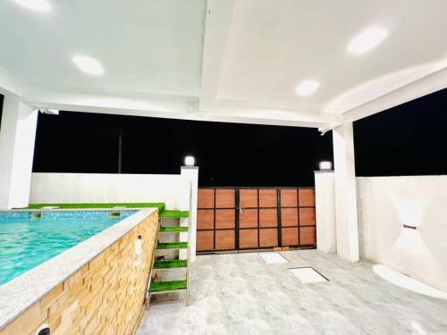 a swimming pool in a building with a pool at HemaRay villa - luxury stay with pool in Chennai