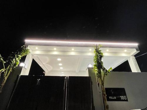 a white house with lights on top of it at HemaRay villa - luxury stay with pool in Chennai