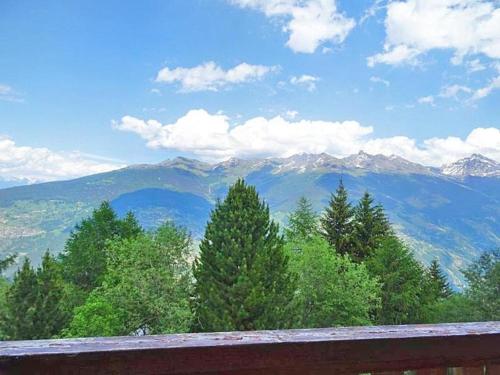 a view of a mountain range from a wooden railing at Chalet Albert in Les Collons