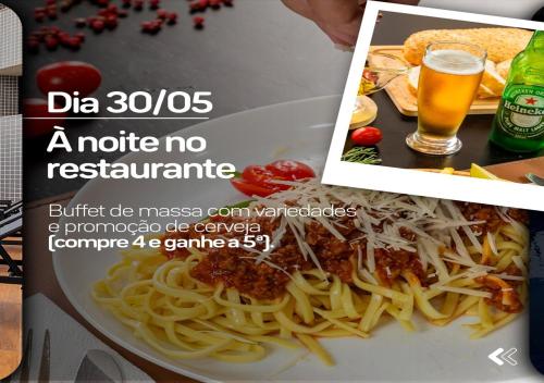 a picture of a plate of pasta and a glass of beer at Hotel Dan Inn Uberlandia in Uberlândia