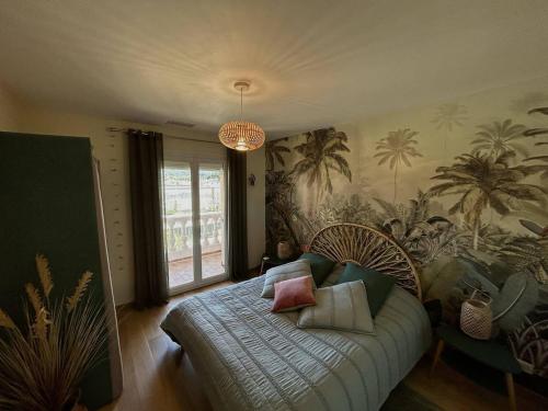 a bedroom with a bed with pillows on it at Sublime Villa Climatisée Familiale avec Extérieurs Spacieux – Quartier Calme - FR-1-388-215 in Argelès-sur-Mer