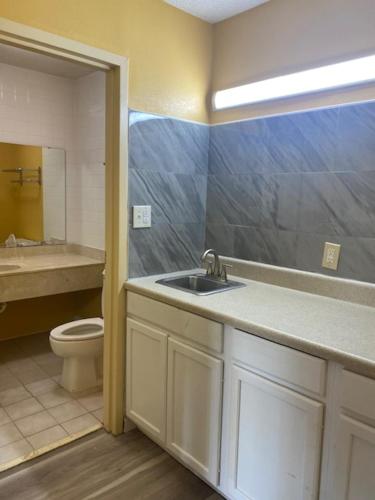 a bathroom with a sink and a toilet at Orangeburg inn & Suites in Orangeburg