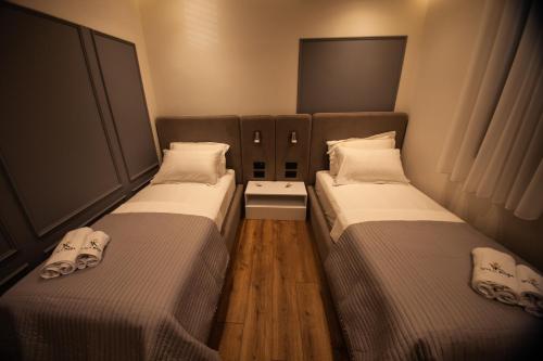 two beds sitting next to each other in a room at Vila Koja Boutique Hotel in Tirana