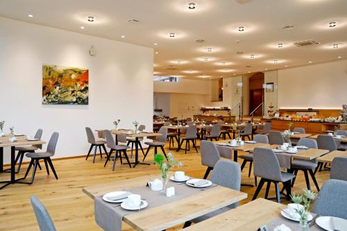 a dining room with wooden tables and chairs at Landhotel Altes Wasserwerk GbR in Freinsheim