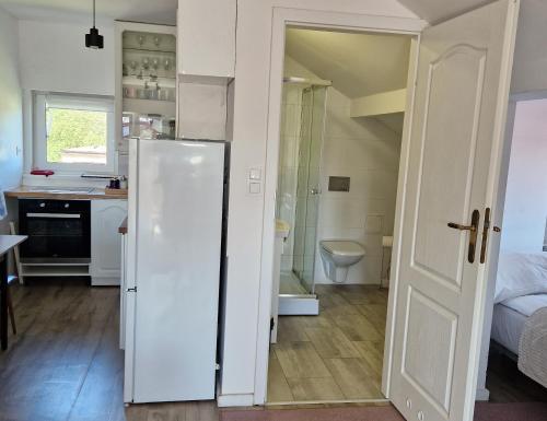 a kitchen with a white refrigerator in a room at Little Wish in Gdańsk
