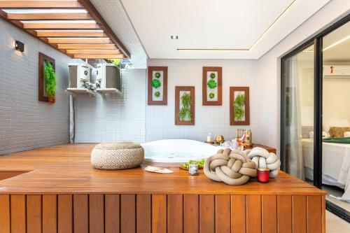 a bathroom with a tub on a wooden counter at Altamare - Pé na areia in Tambaú