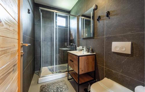 a bathroom with a shower and a sink and a toilet at 3 Bedroom Gorgeous Home In Bilje in Bilje