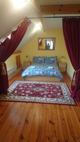 a bedroom with a bed with a rug on the floor at The Barn Annexe, Cefn-Yr-Allt in Crickadarn