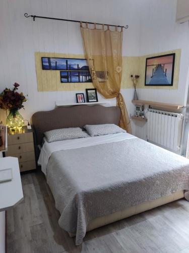 a bedroom with a large bed in a room at Villetta orchidea in Rimini