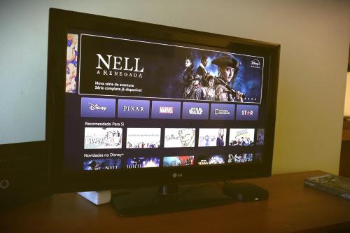 a flat screen tv sitting on top of a table at Sunset Apartment Vila Nova de Gaia in Vila Nova de Gaia
