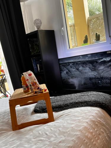 a bedroom with a bed with a table on it at Palais 5min Luxury&Cinema Studio in Cannes
