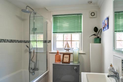 a bathroom with a shower and a sink at Finest Retreats - Nicely Tucked Away Cottage in Torpoint