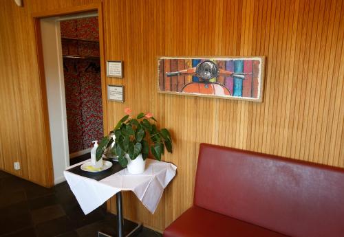 a room with a chair and a table and a window at Sjögestad Motell in Vikingstad