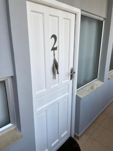 a white door with a number sign on it at Modern and Stylish beach pad with Stunning Ocean View in Ballito