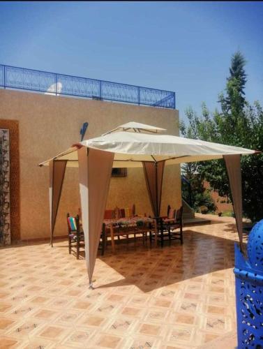 a large white umbrella on top of a patio at sweet home in Marrakech