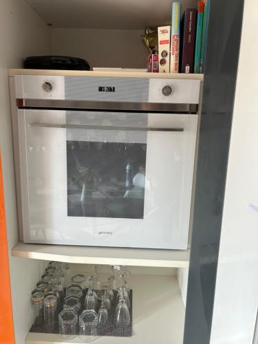 a kitchen with an oven in a shelf with books at Bon Bon del Centro no Ztl a due passi da Piazza Alfieri in Asti