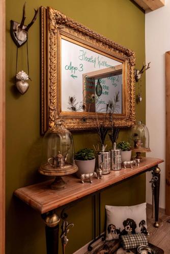 a shelf with a picture and some plants on it at Mountainspirit in Mayrhofen