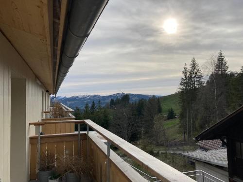 a balcony with a view of the mountains at Gantrisch Lodge Ottenleuebad in Guggisberg