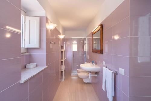 a bathroom with a sink and a toilet and a mirror at SORRENTO BEAUTY in Sorrento