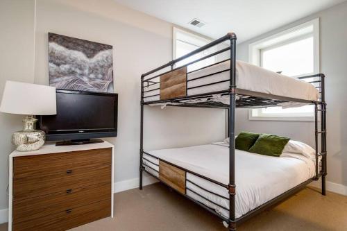 a bedroom with a bunk bed and a flat screen tv at Cozy Beautiful Downtown Unit CHI in Prime River North Location near Mag Mile - 2 in Chicago