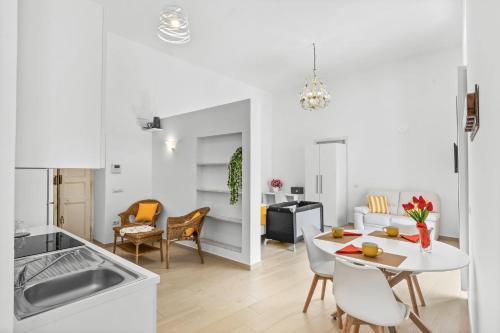 a kitchen and living room with a table and chairs at SORRENTO BEAUTY in Sorrento