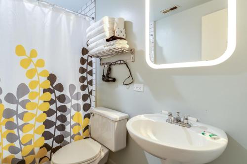 a bathroom with a sink and a toilet and a mirror at Beautifully Remodeled Third Floor Flat in River North - 3N in Chicago