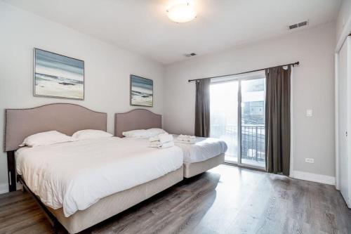 a bedroom with a large bed and a large window at Cozy Beautiful Downtown Unit CHI in Prime River North Location near Mag Mile - 1 in Chicago