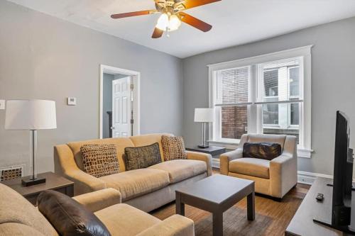 a living room with two couches and a ceiling fan at Historic Second Floor Unit in Shaw Community STL 2W in Tower Grove