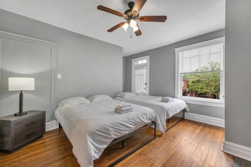 a bedroom with two beds and a ceiling fan at Historic Second Floor Unit in Shaw Community STL 2W in Tower Grove