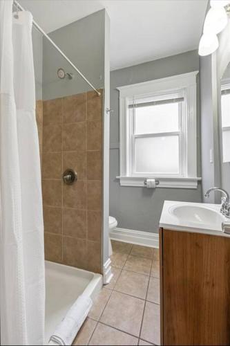a bathroom with a shower and a sink at Historic Second Floor Unit in Shaw Community STL 2W in Tower Grove