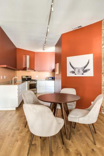 a kitchen and dining room with a table and chairs at Beautifully Remodeled Second Floor Flat in River North - 2N in Chicago