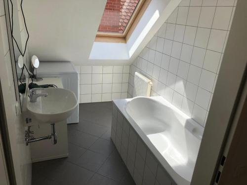 a white bathroom with a sink and a bath tub at Casa di Giovanni - Österreich in Frohnleiten