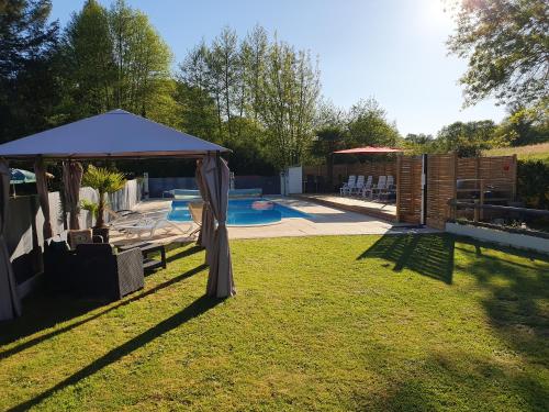 a backyard with a gazebo and a swimming pool at Luxury Safari Tents at Moulin Du Pommier Glamping & Camping in Saulgond