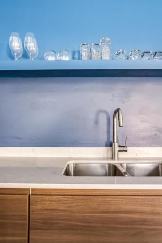 a kitchen counter with a sink and wine glasses at Beautifully Remodeled Second Floor Flat in River North with Private Rooftop - 2S in Chicago