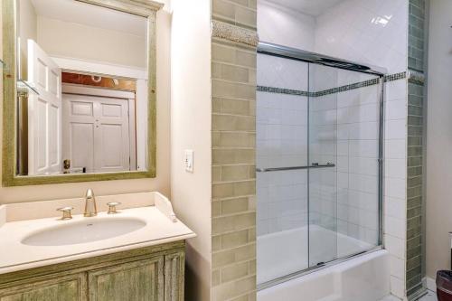 a bathroom with a sink and a glass shower at Historic and Unique Brownstone in Gold Coast - Downtown - 3 in Chicago