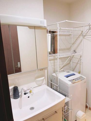 a bathroom with a sink and a toilet and a mirror at 栖禾 seika in Nagoya