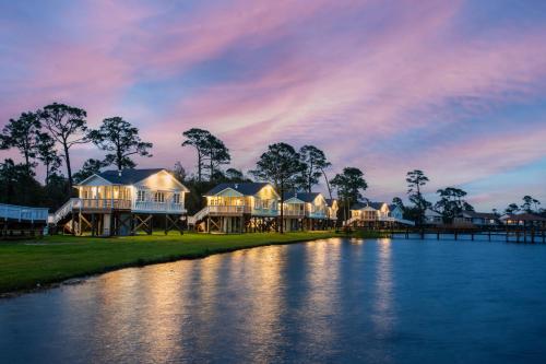 a row of houses on the side of a river at Eagle Cottages & The Cabins at Gulf State Park in Gulf Shores