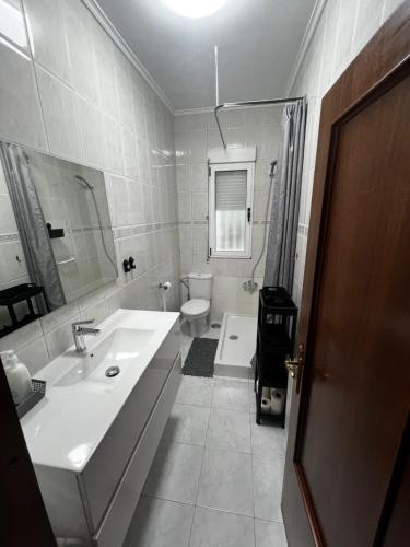 a white bathroom with a sink and a toilet at 3 habitaciones reformado y centrico in Santander